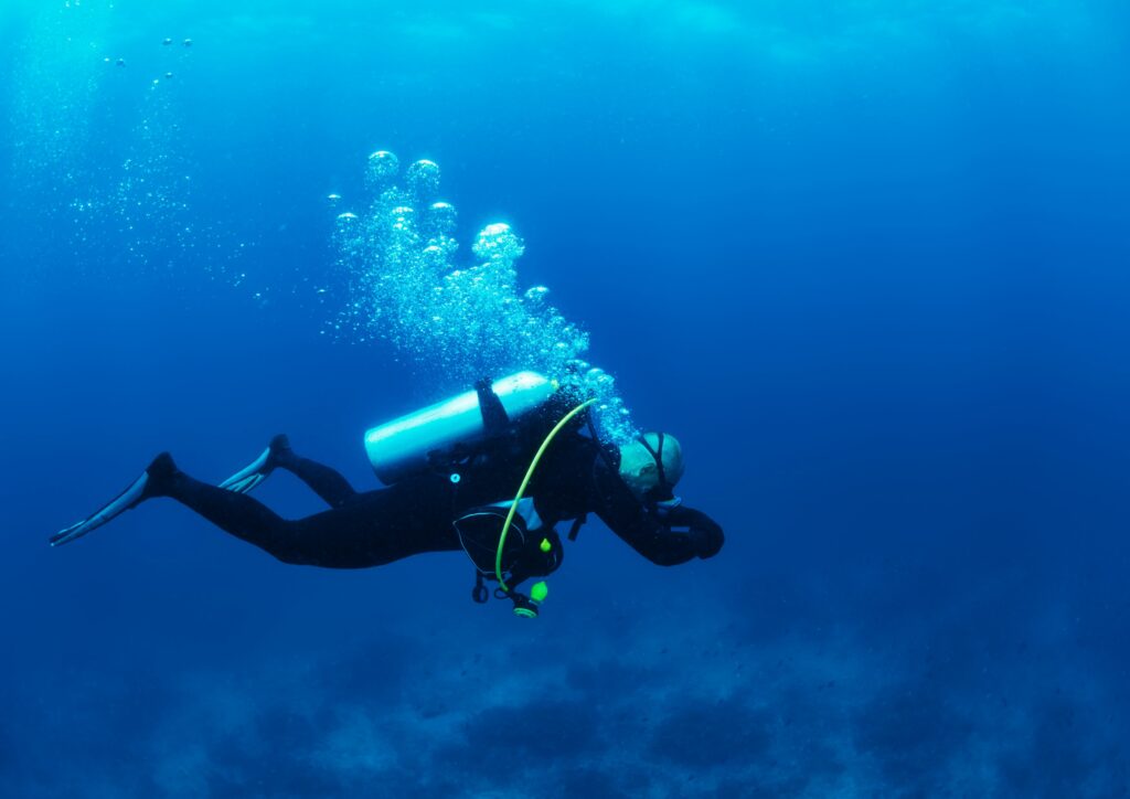 meditative depth of scuba diving - Breathing Diver floating on the sea